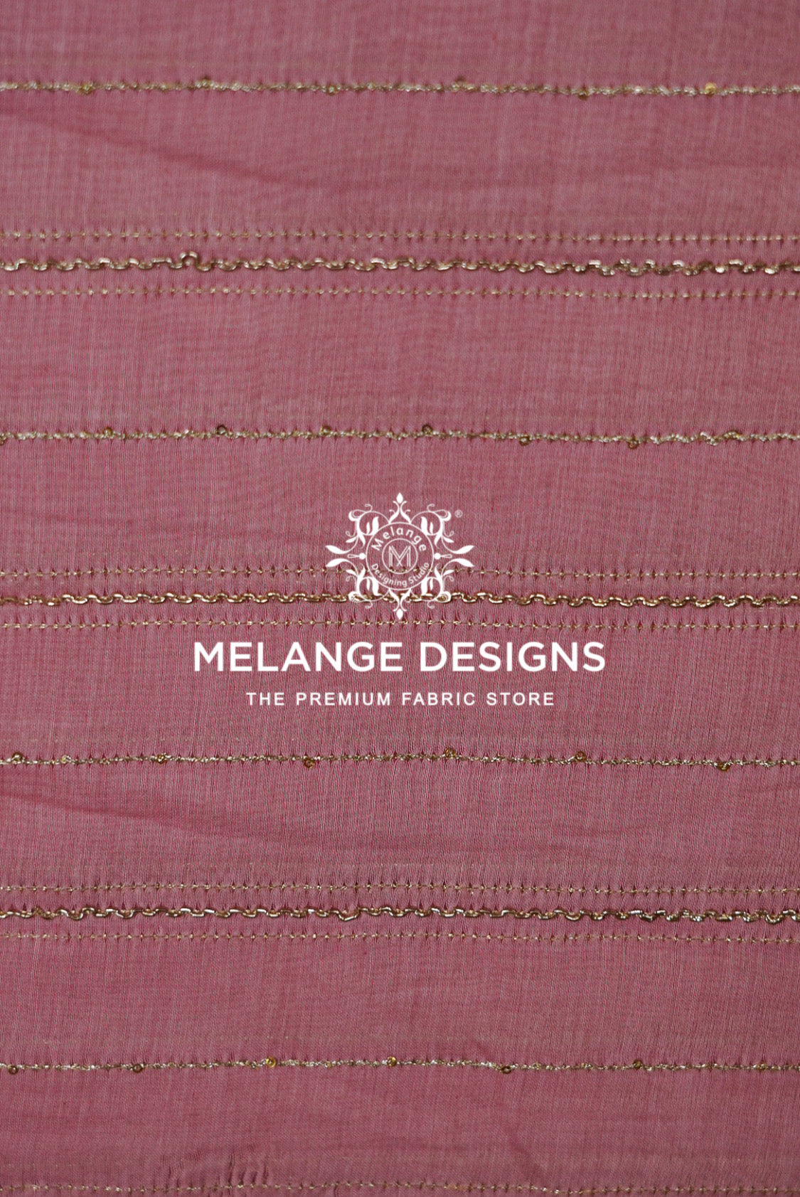 A close-up of dusty rose pink Chanderi Silk Embroidery Fabric with horizontal metallic gold stripes .