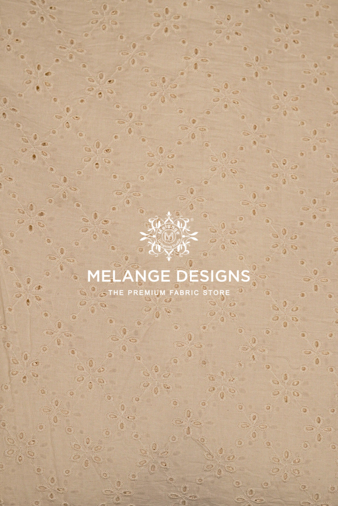 Beige eyelet Cotton Hacoba Fabric Dyeable with a repeating floral eyelet pattern.