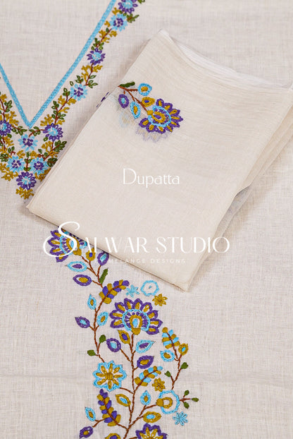 A folded off-white dupatta with colorful floral embroidery in blue, purple, yellow, and green.