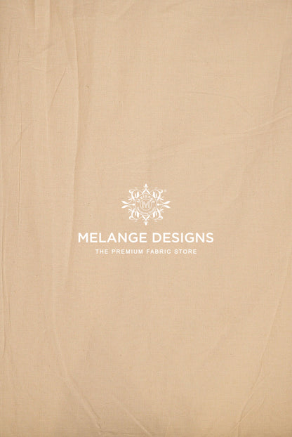 A close-up of a beige Premium Cora Cotton Fabric Dyeable surface.