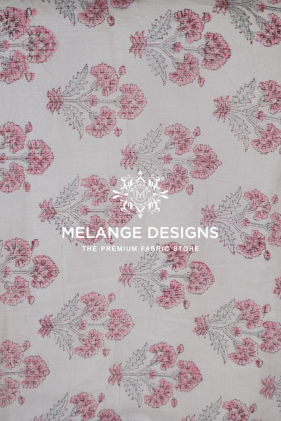 A close-up of a Printed Cotton Cotta Fabric  with a repeating floral block print pattern in pink and gray on a light beige .