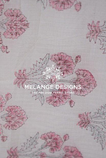 A close-up of a Printed Cotton Cotta Fabric  pattern featuring pink and dusty rose floral motifs on a light beige .