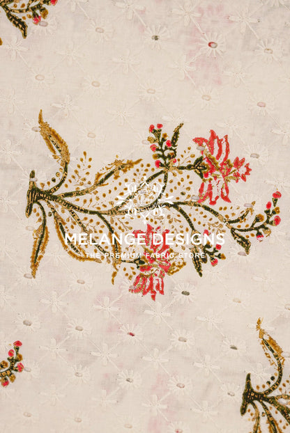 A close-up of a Printed Cotton Hacoba Fabric BJ0047 swatch featuring a light beige base with white floral embroidery and gold and red embroidered floral accents. 