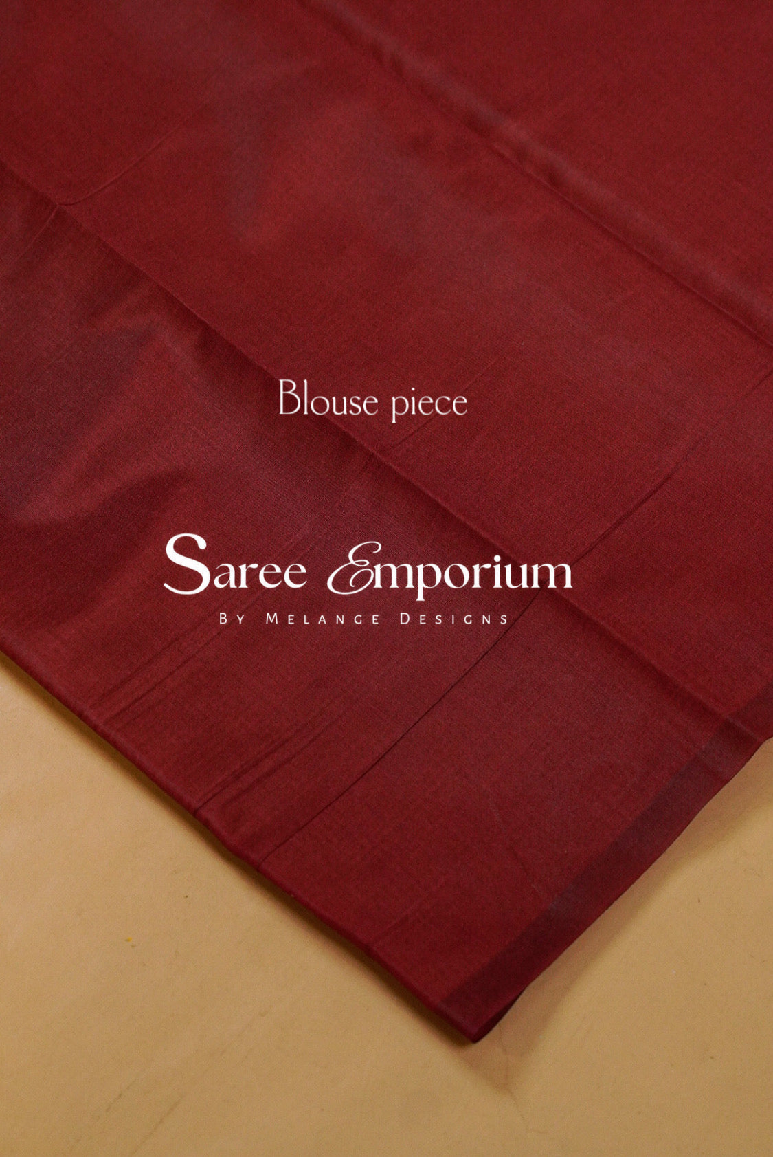 A close-up of a deep maroon red fabric piece with a subtle sheen.