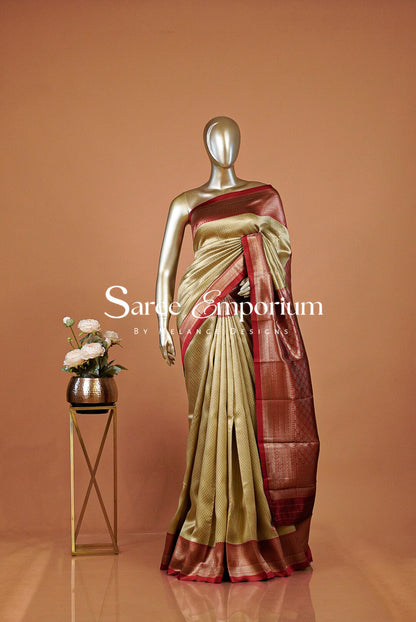 A metallic gold and maroon silk saree . 
