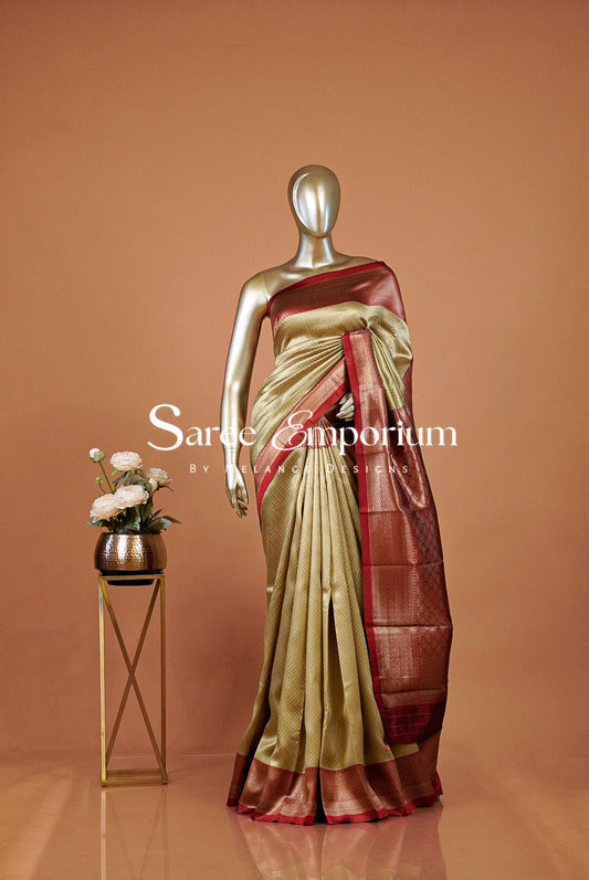 A metallic gold and maroon silk saree . 