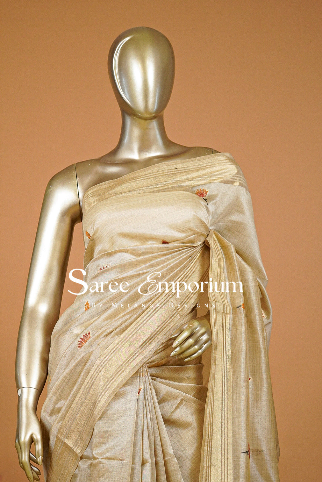Champagne-Gold silk saree with small orange floral motifs.