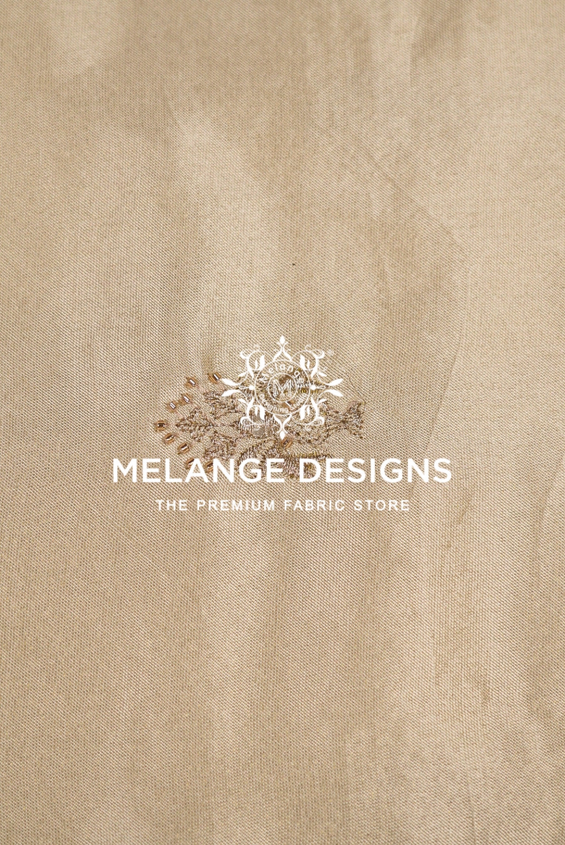 A close-up of a beige Tissue Satin Embroidery Fabric Dyeable surface .