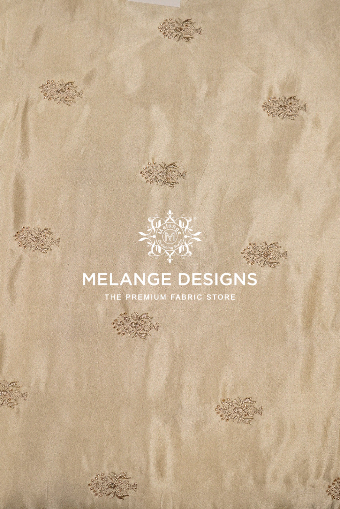 Beige Tissue Satin Embroidery Fabric Dyeable with a subtle sheen and scattered small metallic gold floral motifs.